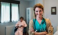 Pretty female doctor posing in a geriatric clinic