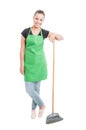 Pretty female employee standing with broom