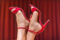 Pretty female feet in red high heel sandals Royalty Free Stock Photo