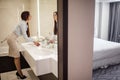 Pretty female in formal wear looking at mirror while washing hands in bathroom Royalty Free Stock Photo