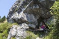 Pretty female hiker resting in rock shelter