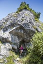 Pretty female hiker resting in rock shelter