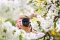 Pretty, female photographer outdoors on a lovely spring day Royalty Free Stock Photo