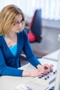 Pretty, female researcher using a microscope in a lab