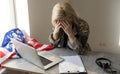 Pretty female soldier working with laptop while sitting at table in headquarters building.