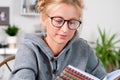 Pretty female student girl with books studying at home. Royalty Free Stock Photo