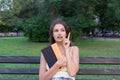 Pretty female student is holding a book and thinking about something. Woman has an interesting idea Royalty Free Stock Photo