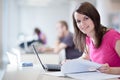 Pretty female student with laptop