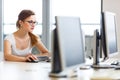 Pretty, female student looking at a desktop computer screen Royalty Free Stock Photo