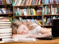 Pretty female student sleep in library Royalty Free Stock Photo