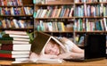 Pretty female student sleep in library Royalty Free Stock Photo