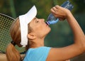 Pretty female tennis player drinking water Royalty Free Stock Photo