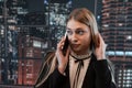 Pretty female worker stands at office and talks on the phone Royalty Free Stock Photo