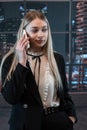 Pretty female worker stands at office and talks on the phone Royalty Free Stock Photo