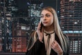 Pretty female worker stands at office and talks on the phone Royalty Free Stock Photo