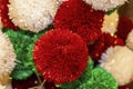 Pretty Festive Christmas Holiday background of Red Green and White sparkly pompom balls - some in focus and some blurred and boke Royalty Free Stock Photo