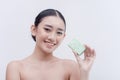 A pretty Filipina lady holding a gentle and moisturizing facial soap for acne-prone skin. Beauty care treatment Royalty Free Stock Photo