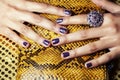 Pretty fingers of african american woman holding money closeup with purse, luxury jewellery on python clutch, cash for Royalty Free Stock Photo
