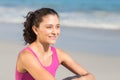 Pretty fit brunette sitting beside the sea Royalty Free Stock Photo