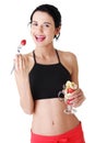 Pretty fit girl eating fruit salad Royalty Free Stock Photo