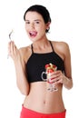 Pretty fit woman eating fruit salad Royalty Free Stock Photo