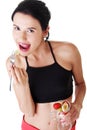 Pretty fit woman eating fruit salad Royalty Free Stock Photo