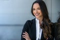 Pretty, friendly, charming, likable brunette businesswoman head shot portrait at the office workplace, happy and smiling Royalty Free Stock Photo