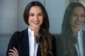 Pretty, friendly, charming, likable brunette businesswoman head shot portrait at the office workplace, happy and smiling Royalty Free Stock Photo