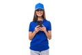 pretty friendly young promoter woman in blue cotton t-shirt and cap with smartphone