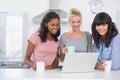 Pretty friends having coffee together and looking at laptop Royalty Free Stock Photo