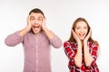 Pretty funny cheerful couple showing surprise