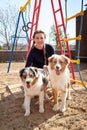 Pretty funny girl with nice dog at children playground in the yard of city in a sunny day Royalty Free Stock Photo