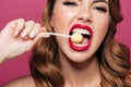 Pretty funny lady eating lollipop like watermelon isolated Royalty Free Stock Photo