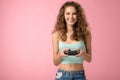 Pretty gamer girl isolated on pink background