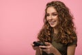 Pretty gamer girl on pink background