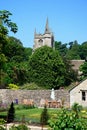 Pretty garden and church tower, Castle Combe. Royalty Free Stock Photo