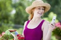 Pretty gardener with cell phone Royalty Free Stock Photo