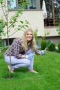 Pretty gardener woman with gardening tools