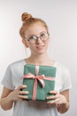 Pretty ginger girl with hairbun has got a gift box on Valentines day