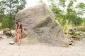 Pretty girl by Alien stone at viewpoint to volcano Merapi