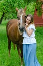 Pretty girl and bay peasant horse