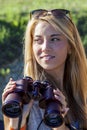 Pretty girl with binoculars looking at the horizon Royalty Free Stock Photo