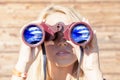 Pretty girl with binoculars looking at the horizon Royalty Free Stock Photo