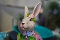 Pretty girl bunny rabbit all decked out for spring with flowers and ribbons against bokeh background