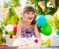 Pretty girl with cake at birthday party Royalty Free Stock Photo