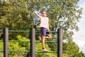 A pretty girl climbed the Swedish wall to play with a children`s plane.