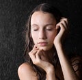 Pretty girl with close eyes in water studio