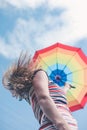 Pretty girl in dress holding rainbow umbrella on Royalty Free Stock Photo