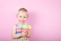 Pretty girl eating ice cream in front of pink background Royalty Free Stock Photo