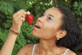 Pretty girl eating a strawberry